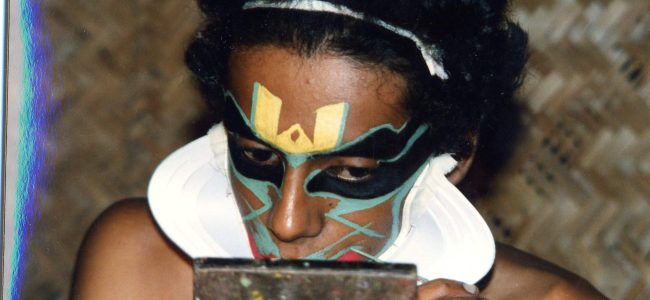 Kathakali performer engaged in make-up. S India